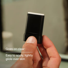Harry's anti-shine stick in hand for scale showing pocket-ready size and portability