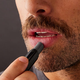 Harry's lip balm in a dopp kit lifestyle image showing practical carry and daily-use benefit