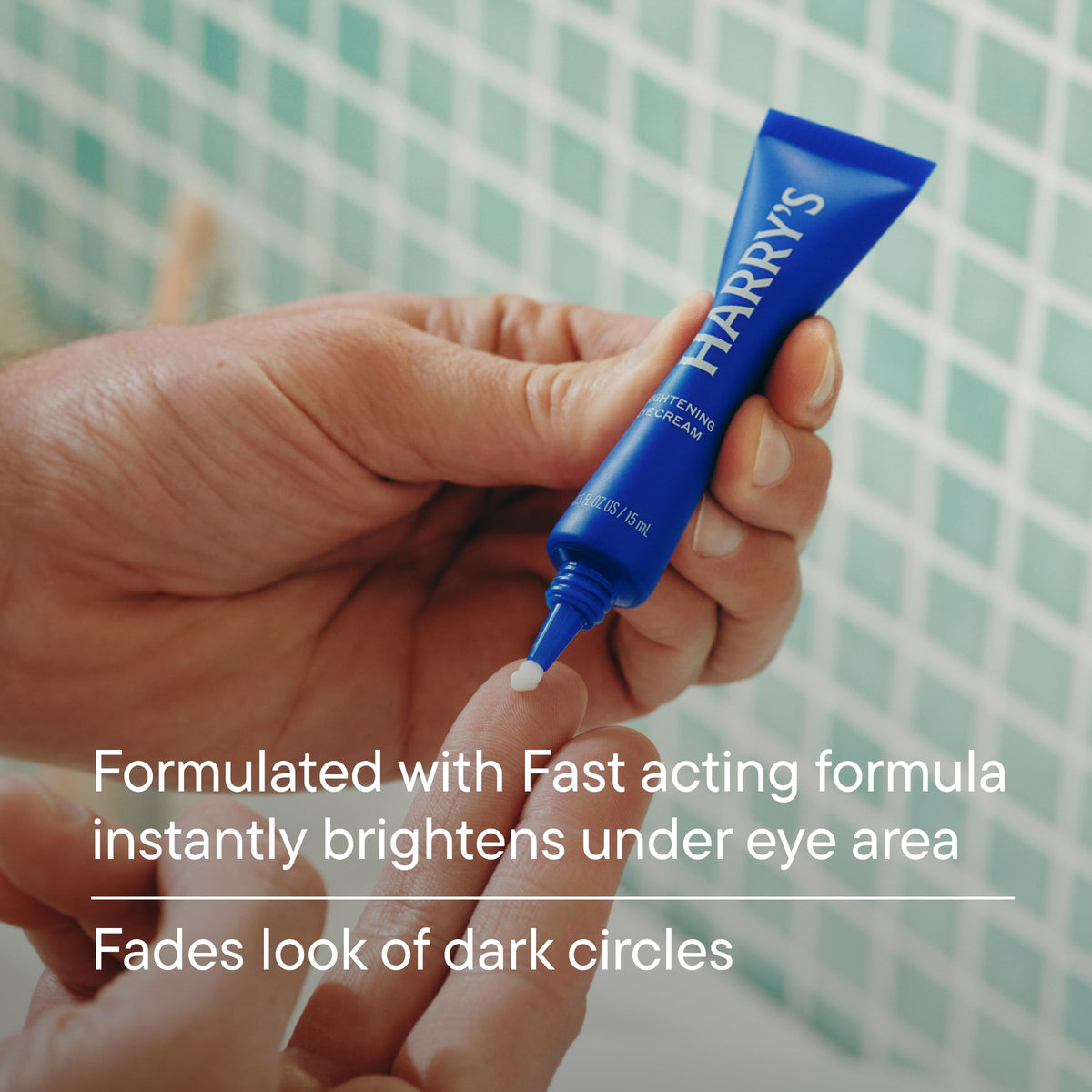 Person applying Harry's eye cream with ring finger to reduce dark circles