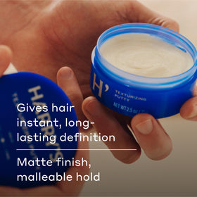 Harry's hands applying putty illustrating effortless styling benefit