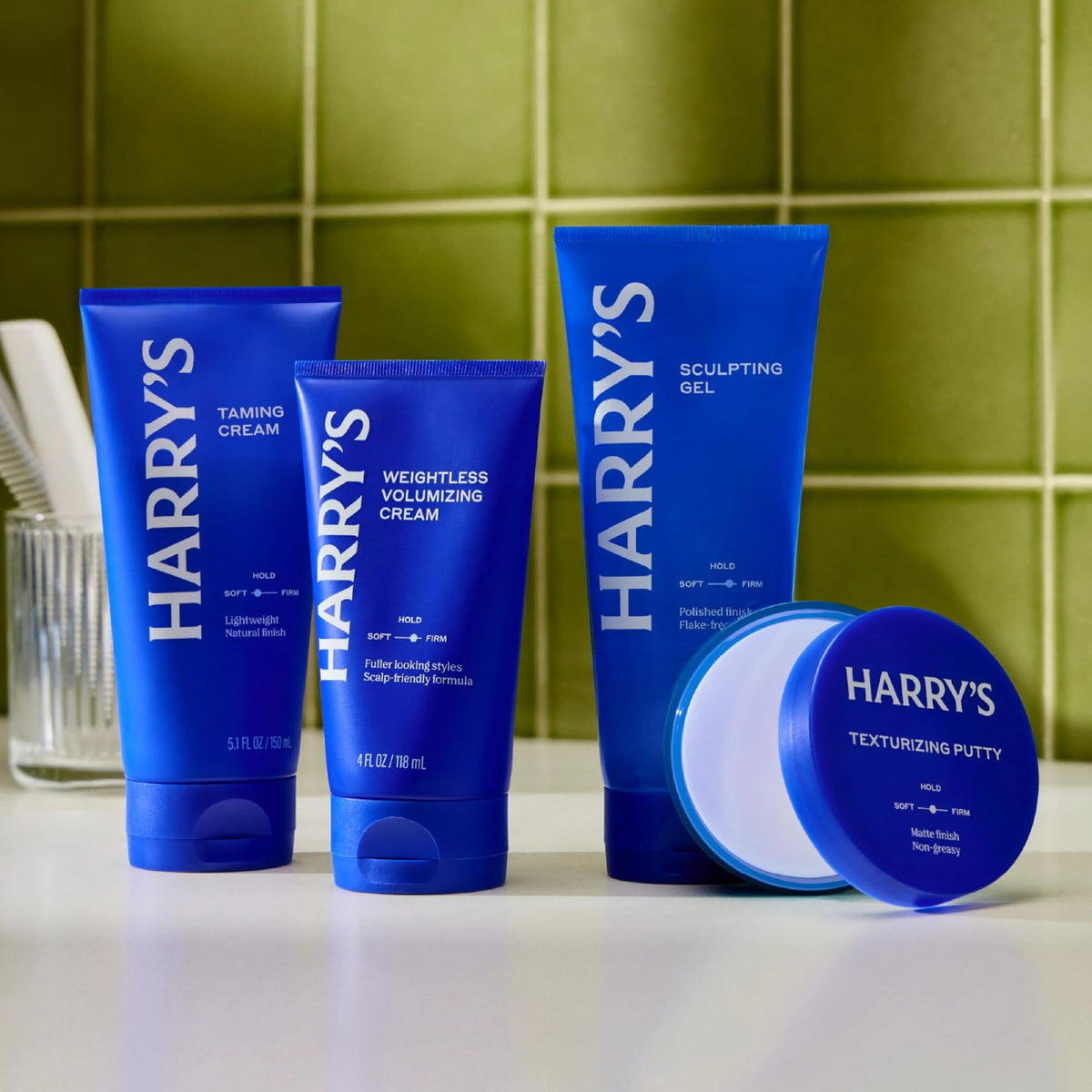 Man styling hair with Harry's cream in bathroom mirror demonstrating effortless everyday volume