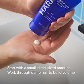 Hands applying Harry's cream to hair demonstrating easy distribution and instant lift