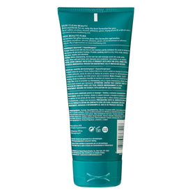HASK application massaging scrub into scalp to remove buildup and flakes