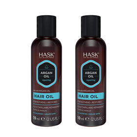 HASK applying oil to wet hair to reduce frizz and protect while styling