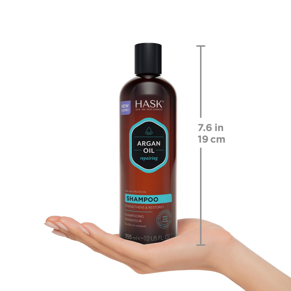 HASK 12 fl oz bottle held in hand to illustrate realistic size