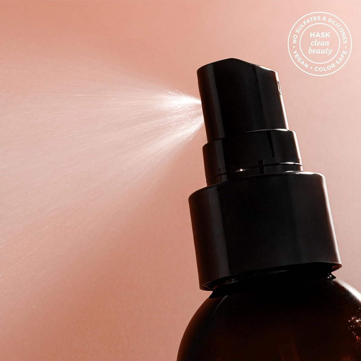 HASK coconut spray being applied to wet hair to detangle and protect
