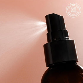 HASK coconut spray being applied to wet hair to detangle and protect