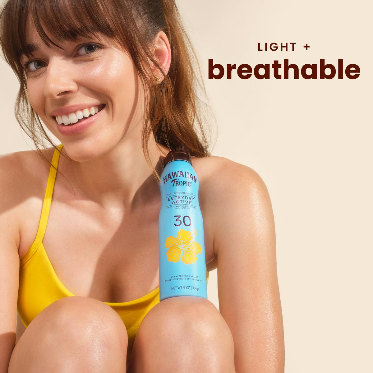 Hawaiian Tropic clear spray action on skin showing non‑greasy finish
