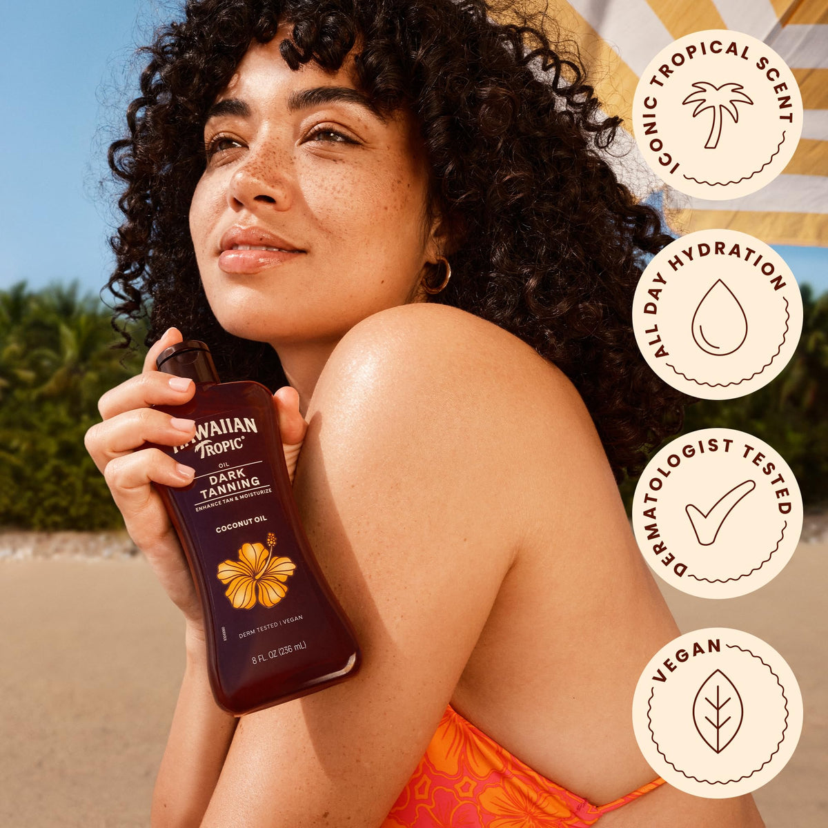 Hawaiian Tropic bottle on sandy beach displaying tropical fragrance vibe