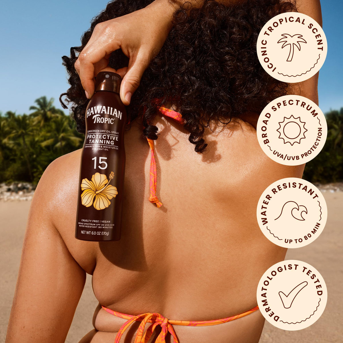 Hawaiian Tropic spray being applied on skin at the beach for hydrated tan