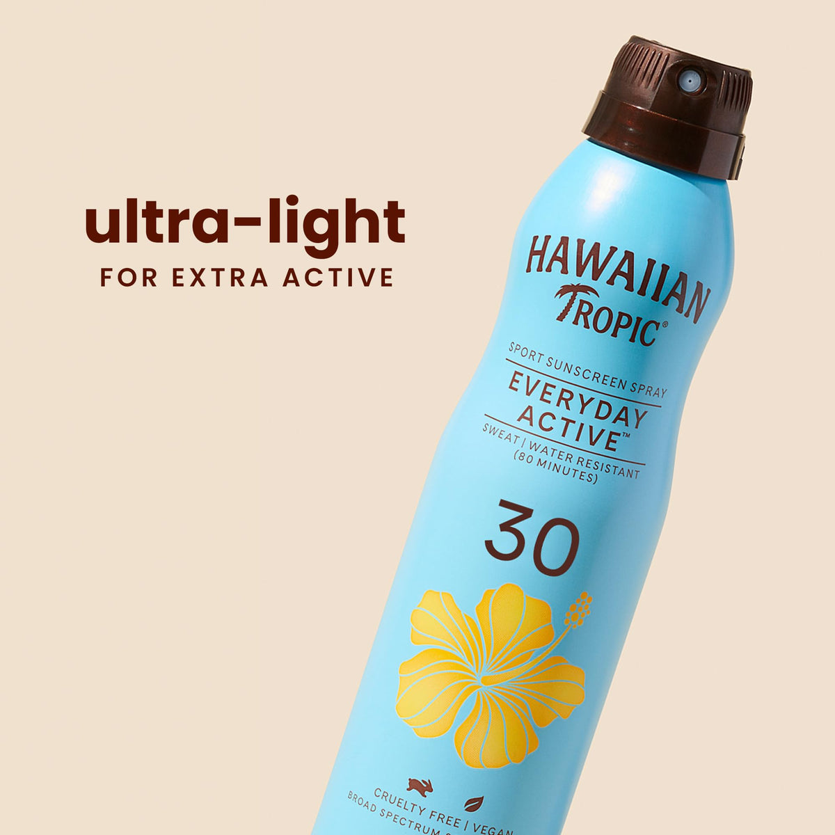 Hawaiian Tropic spray application on arm showing clear, quick drying benefit