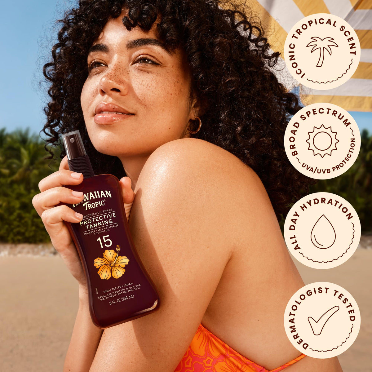 Hawaiian Tropic spray being applied at the beach for water-resistant coverage