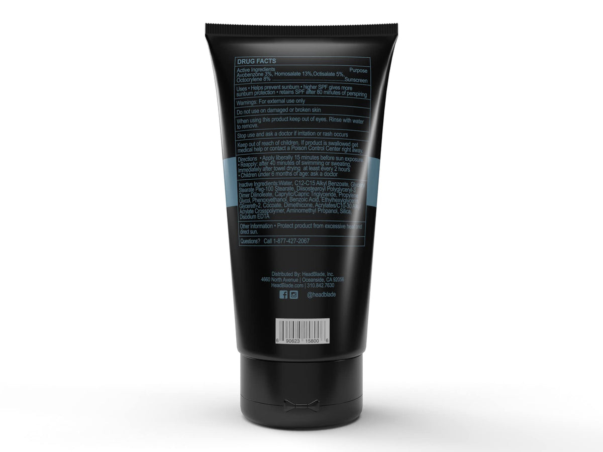 Hand holding HeadBlade HeadLube to show 5 fl oz size and travel convenience