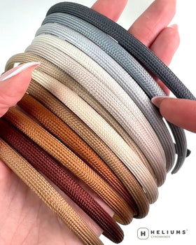 Heliums headband next to ruler illustrating slim 8mm scale benefit