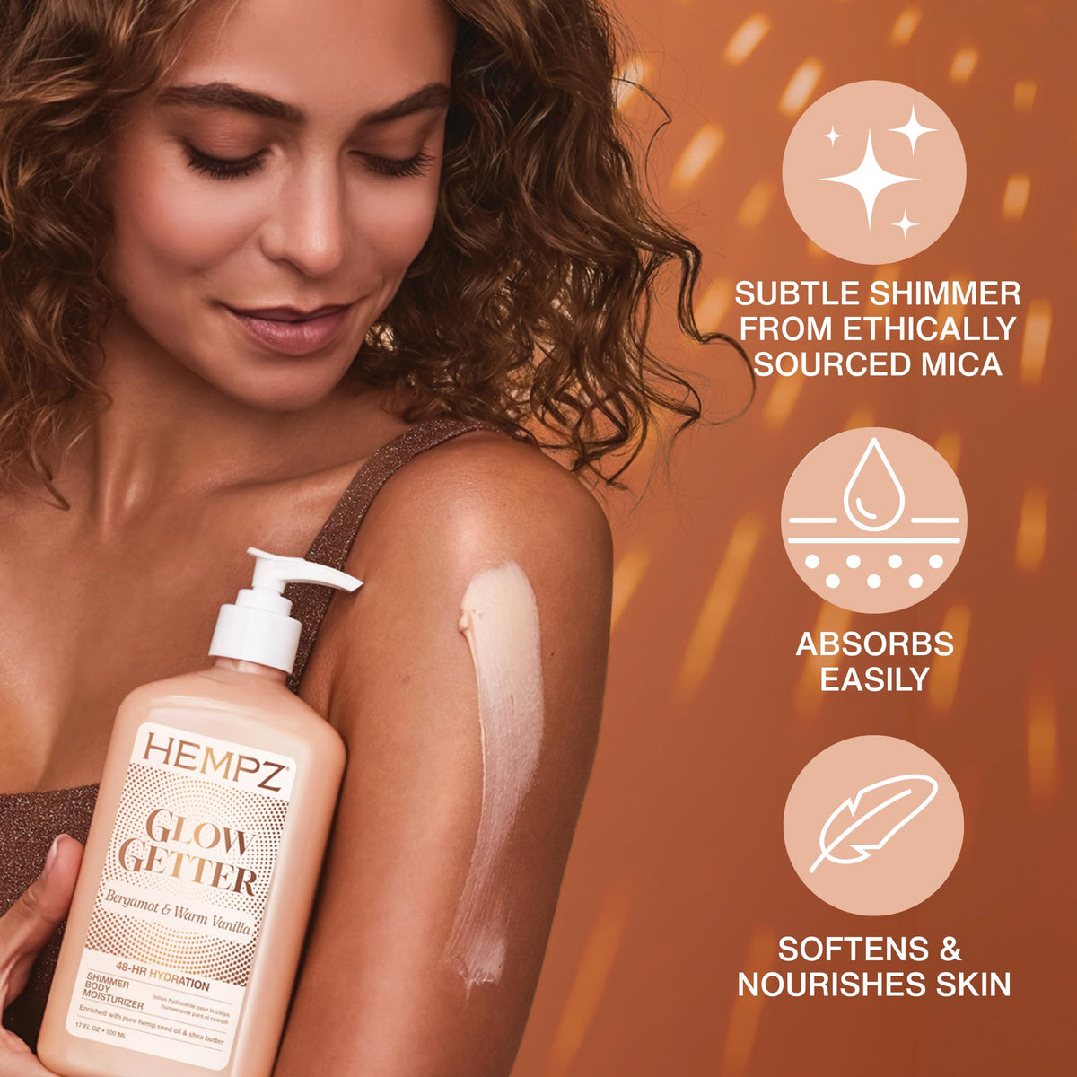 Person applying Hempz to shoulder demonstrating subtle glow and moisturized skin