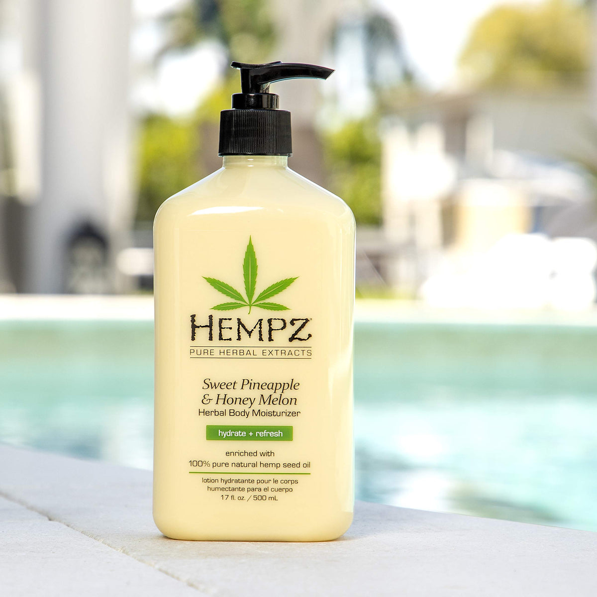 Hempz bottle held in hand showing 17 oz scale benefit