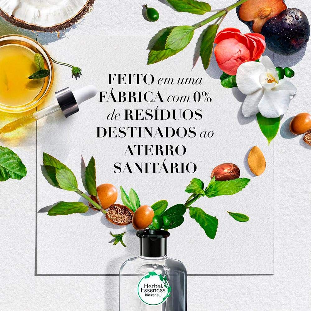 Herbal Essences conditioner in hand showing bottle size and scale