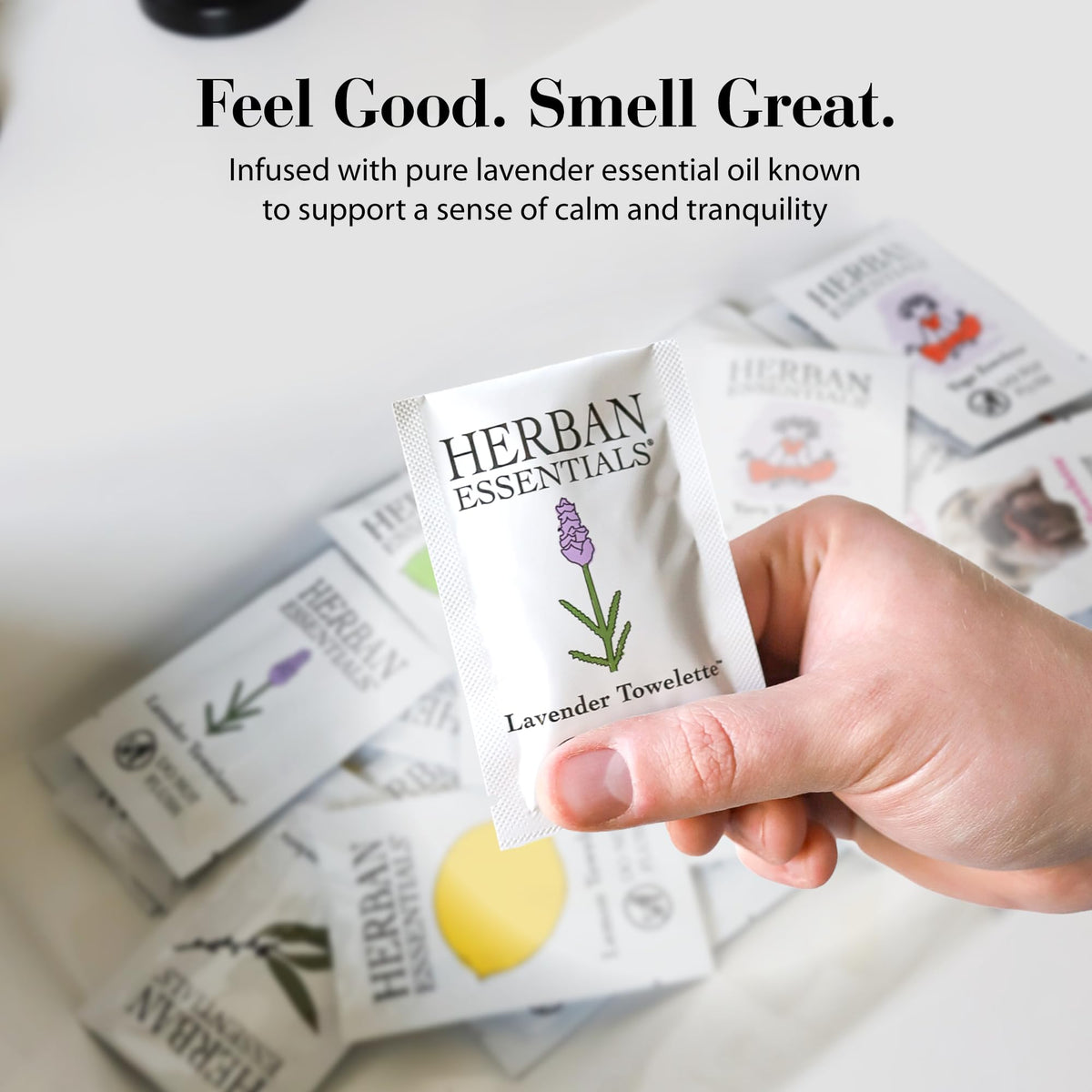 Herban Essentials towelette cleaning a phone screen demonstrating surface-cleaning utility
