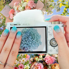heyhae worn on hands lifestyle photo showing polished ombré blue for stylish wear