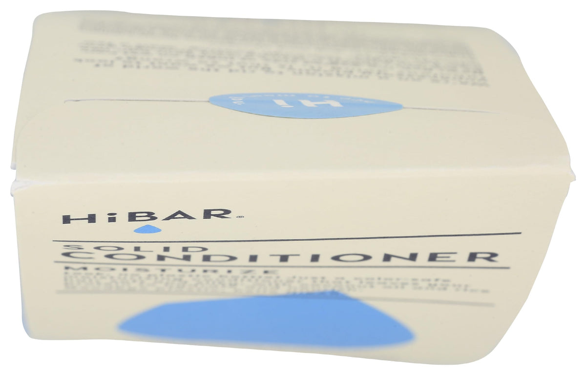 HiBAR bar held in hand for scale showing compact, travel-friendly solid conditioner benefit