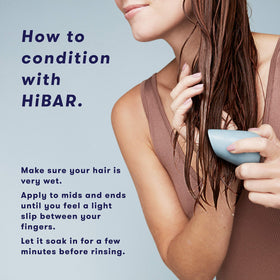 HiBAR bars in hand for size comparison showing compact travel-friendly design benefit.