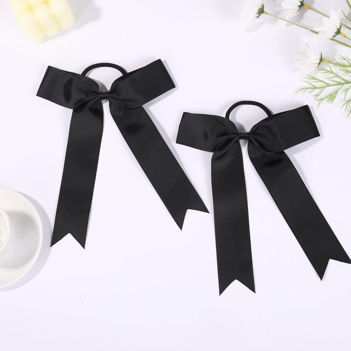 Hipcheer bow worn on ponytail during cheer movement demonstrating secure hold benefit