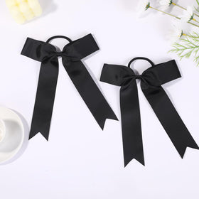 Hipcheer bow worn on ponytail during cheer movement demonstrating secure hold benefit