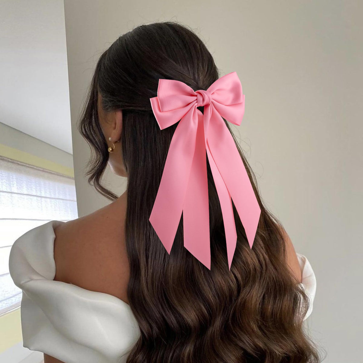 hisial bow worn on a high ponytail, adds polished decorative accent