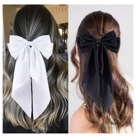hisial bow clipped on a ponytail adding instant polished style