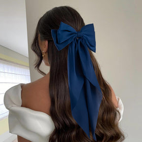 hisial bow used on a half-up hairstyle showing elegant finish for event wear