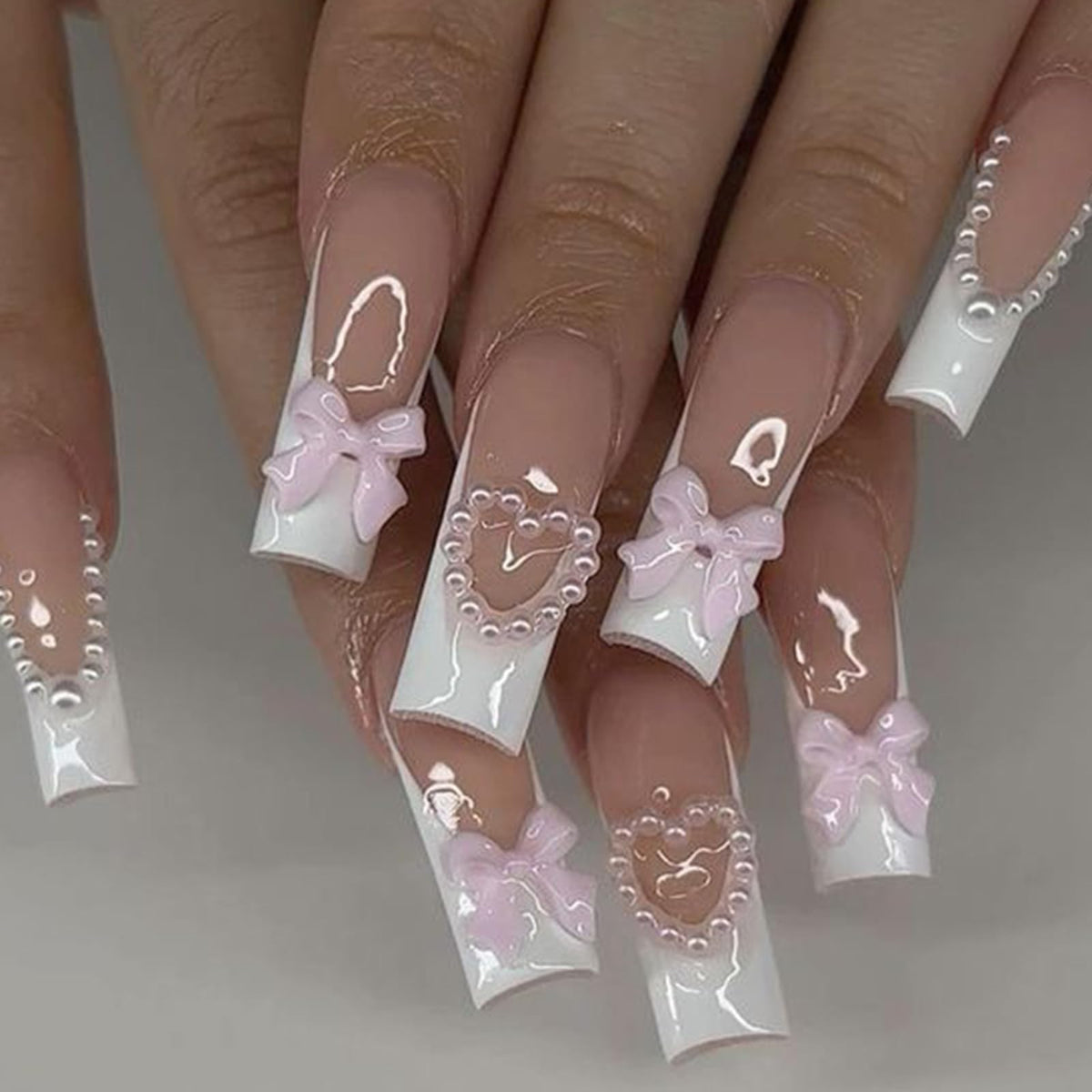 HNUIX charms applied on acrylic nail example illustrating elegant finished look
