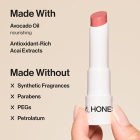 Honest Beauty plum drop applied on model lips highlighting hydrated glossy finish