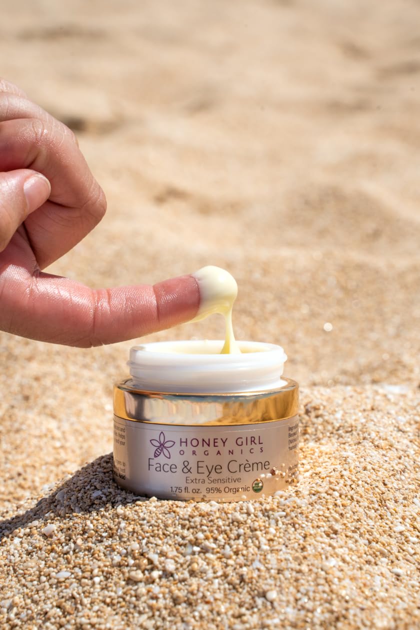 Finger dipping small amount of Honey Girl Organics creme to demonstrate concentrated application