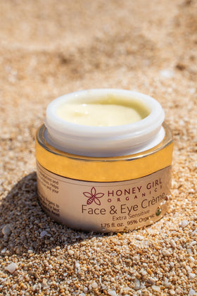 Honey Girl Organics jar on a bathroom vanity showing natural skincare for sensitive routines