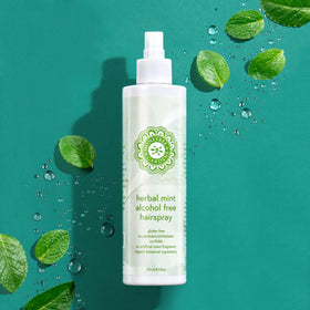 Honeybee Gardens stylist spraying hair in salon to show professional application benefit