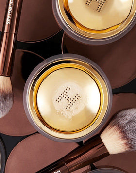HOURGLASS powder applied under eyes to set concealer and prevent creasing