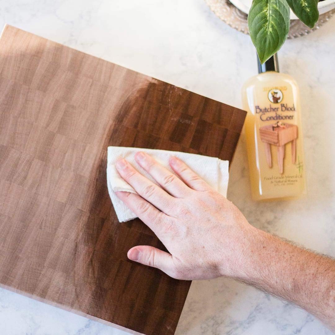 Howard BBC012 being applied to a cutting board with a cloth showing improved moisture