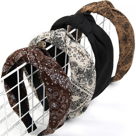 Huachi front view of four headbands showing knotted tops and prints, stylish utility