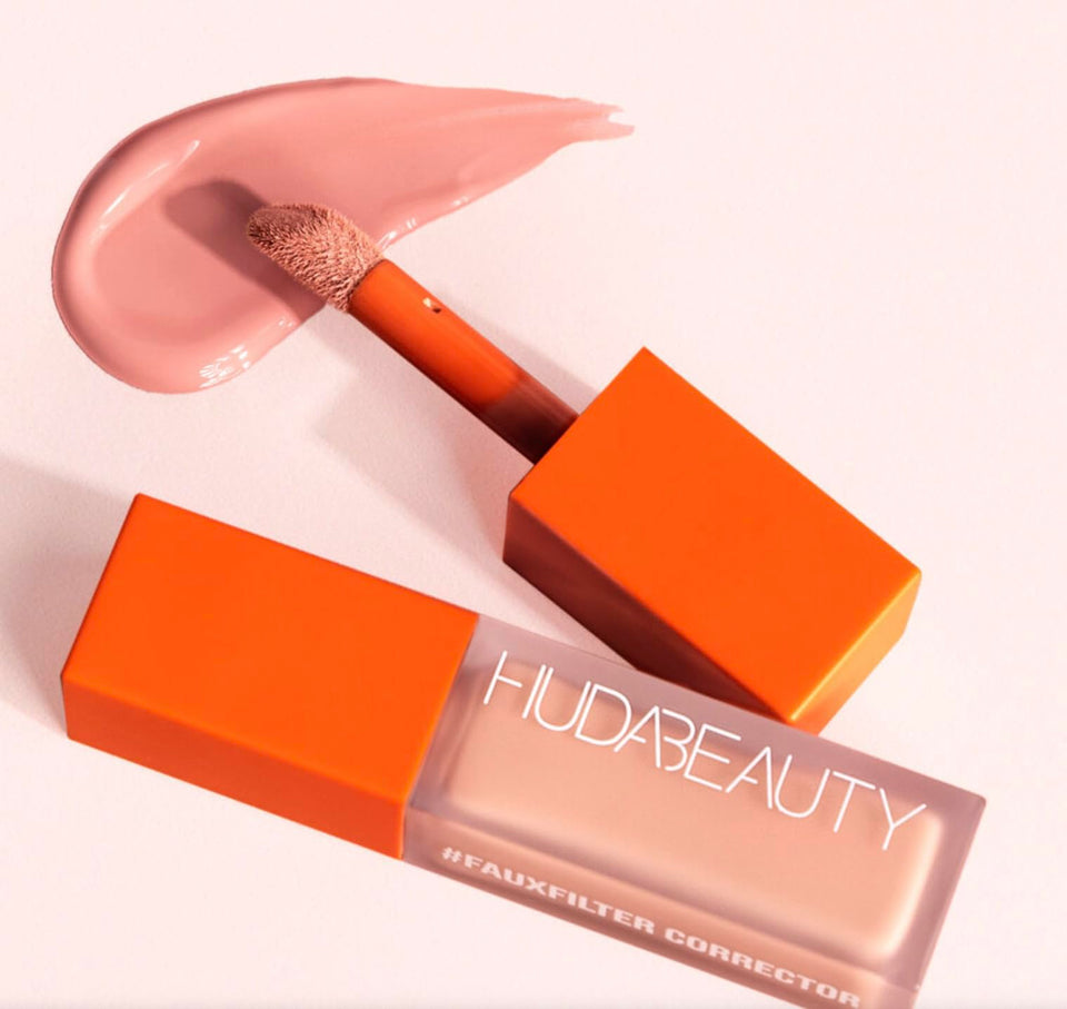 HUDA #FAUXFILTER peach corrector tube front view showing applicator and brand for bright, crease-resistant coverage