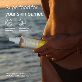 HUME SUPERNATURAL bottle in beach setting suggesting fresh scent and summertime hydration benefit