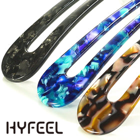 HYFEEL hair fork next to a hand for scale, showing long two-prong size and comfortable grip