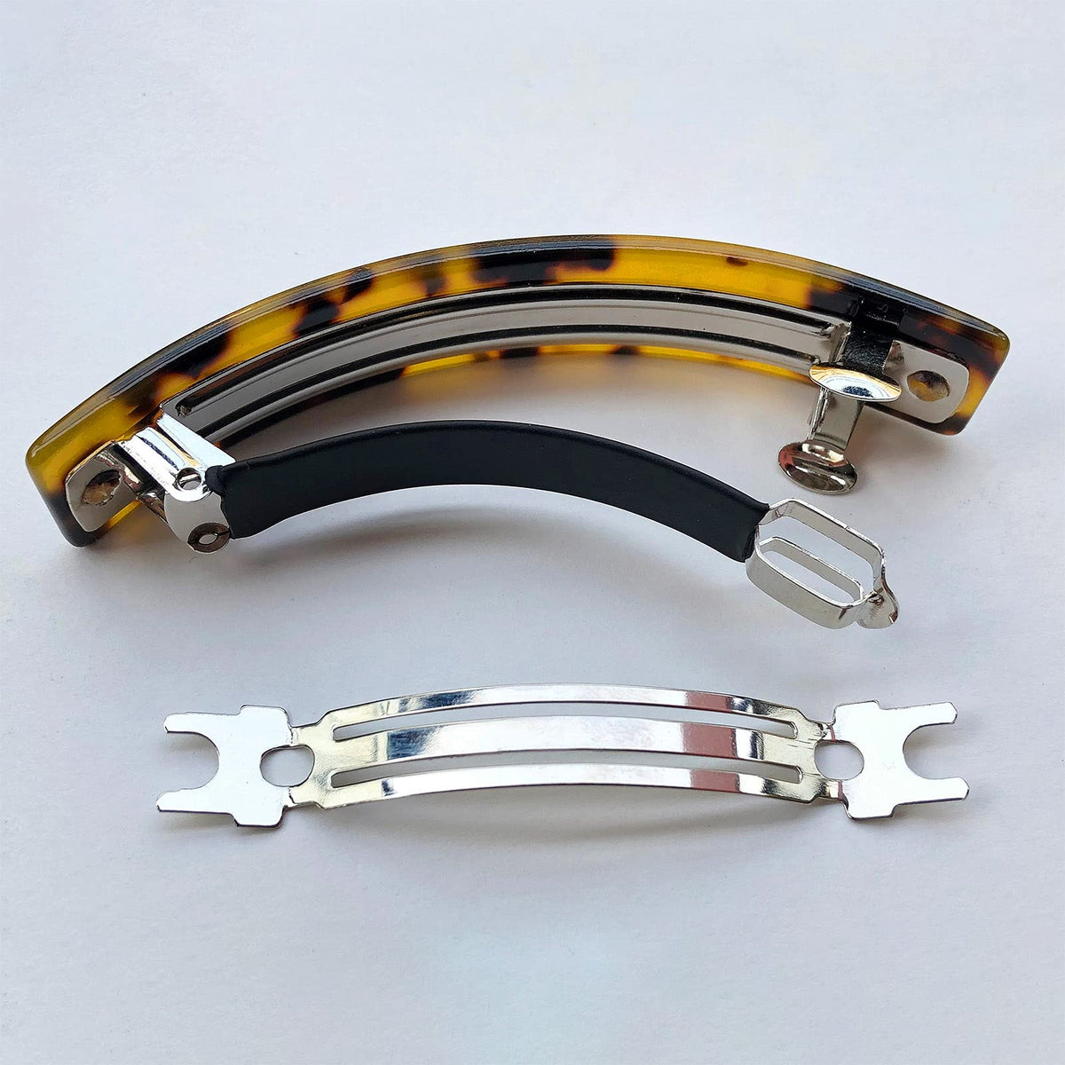HYFEEL barrette next to a hand showing true 3.5-inch size and scale