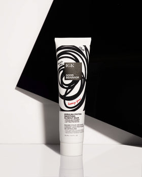 IGK balm applied to damp hair mid-lengths showing easier blow-dry manageability