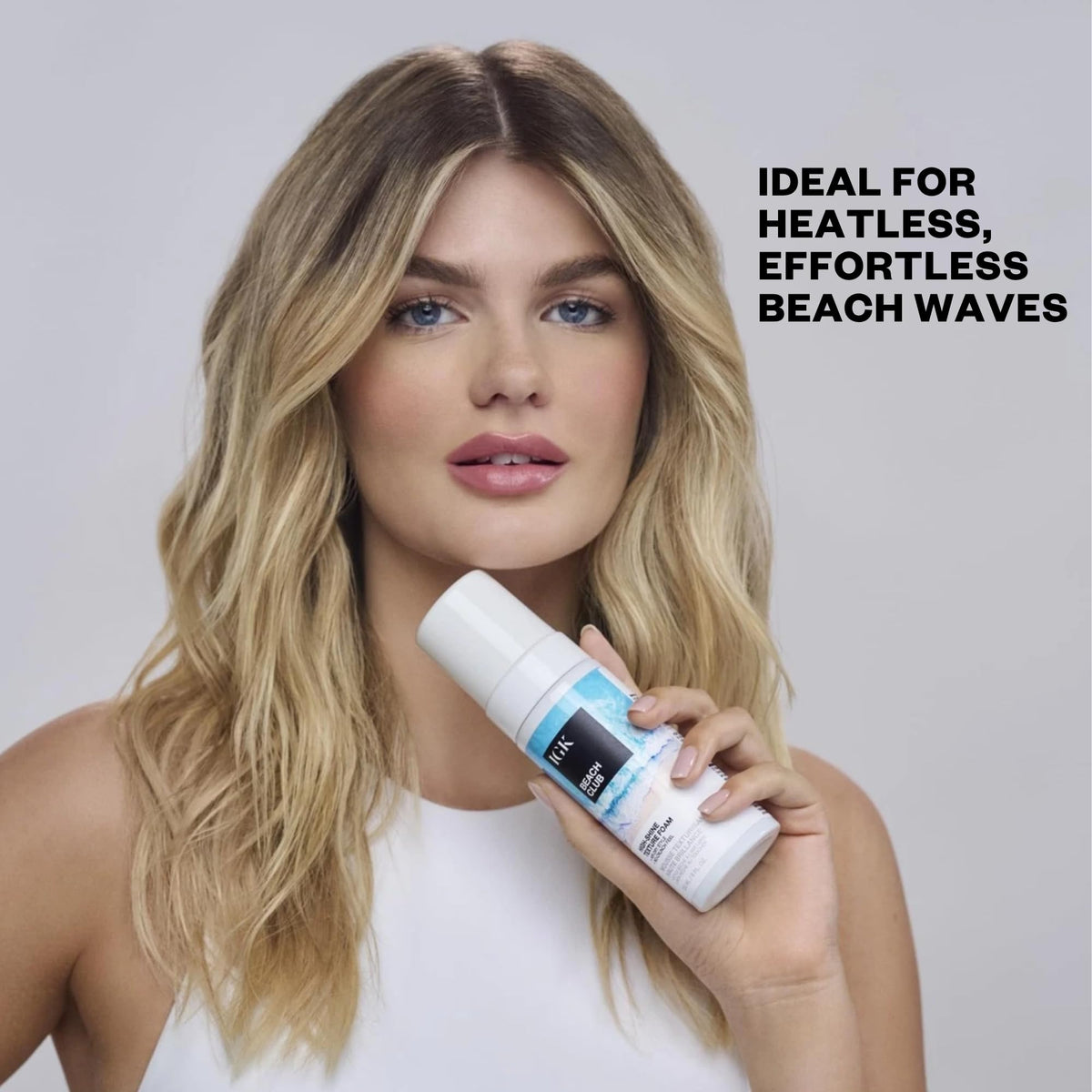 IGK product in a beach setting illustrating UV protection and summer-ready styling