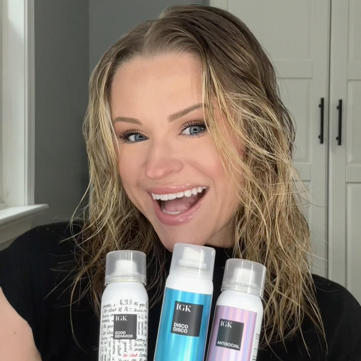 IGK lifestyle image of traveler using the kit for salon-like results on the go