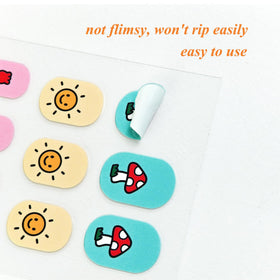 IHUKEIT child wearing finished nail wraps showcasing playful designs and safe finish