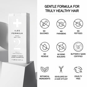 ILES FORMULA bottle staged in bathroom conveying everyday salon results