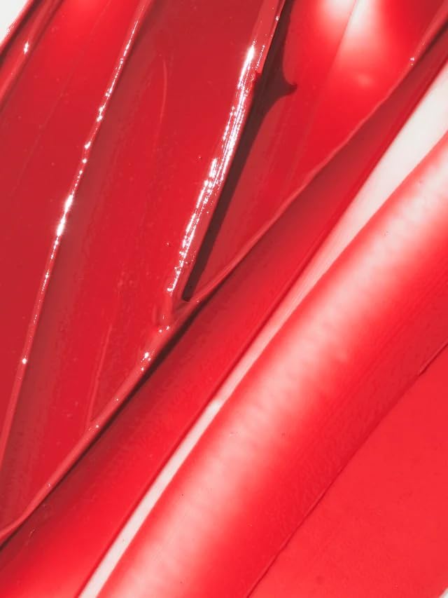ILIA artisan hand pouring Balmy Tint to show small-batch quality and formula care