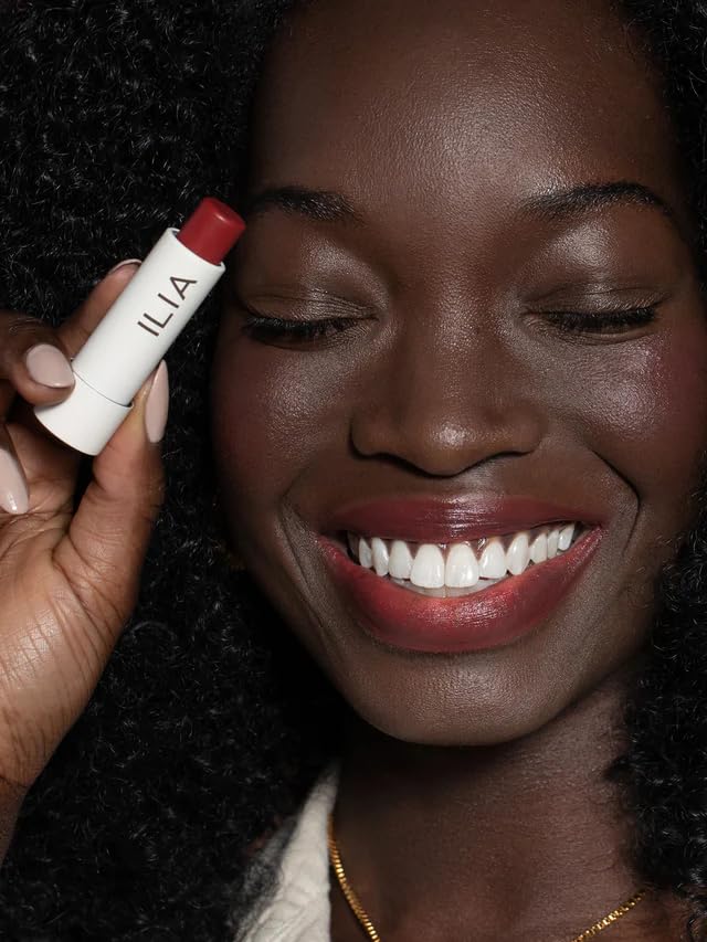 ILIA Balmy Tint next to a credit card illustrating compact travel-friendly size