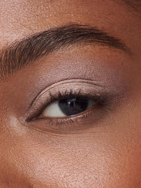 ILIA product applied on model eyelid offering weightless shimmer and photo-ready benefit